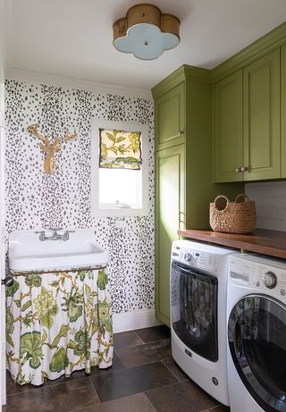 small laundry room ideas with curtain storage and green cabinets by Kim Amrstrong