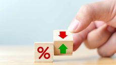 Wooden blocks with percentage sign and green and red arrows