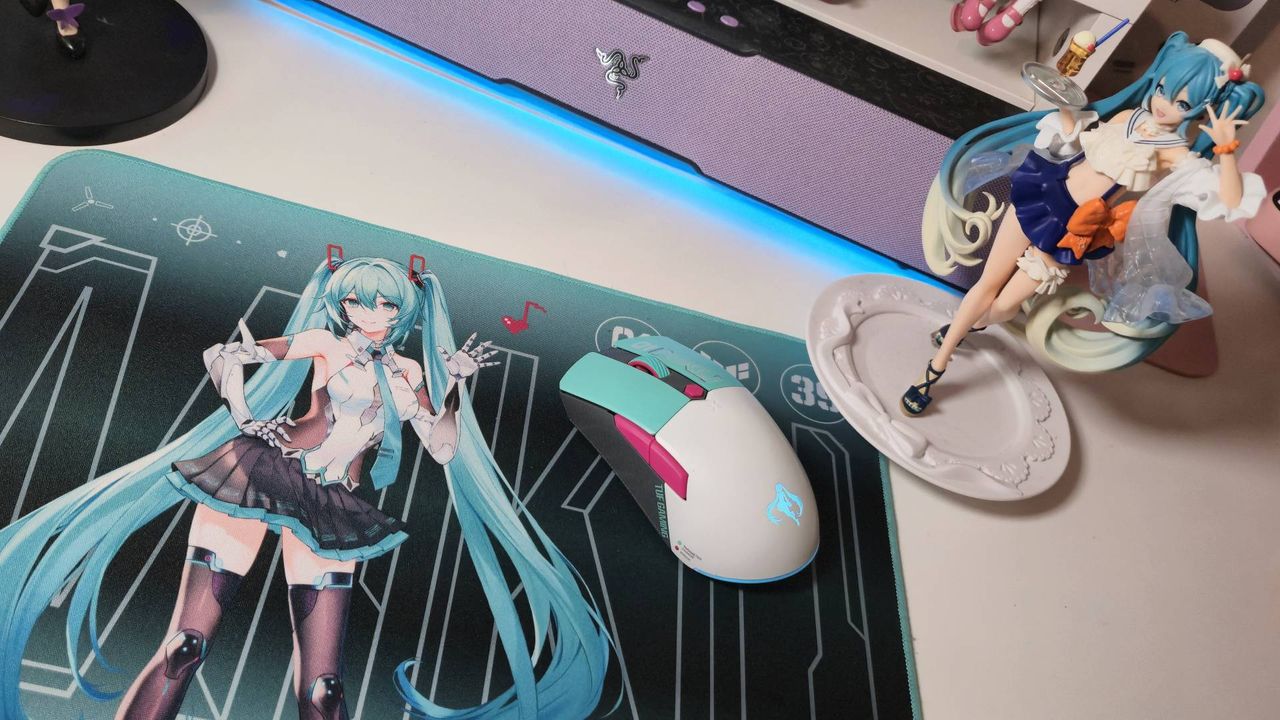 Photo of the Asus TUF Gaming Hatsune Miku mouse pad sitting on a white desk.