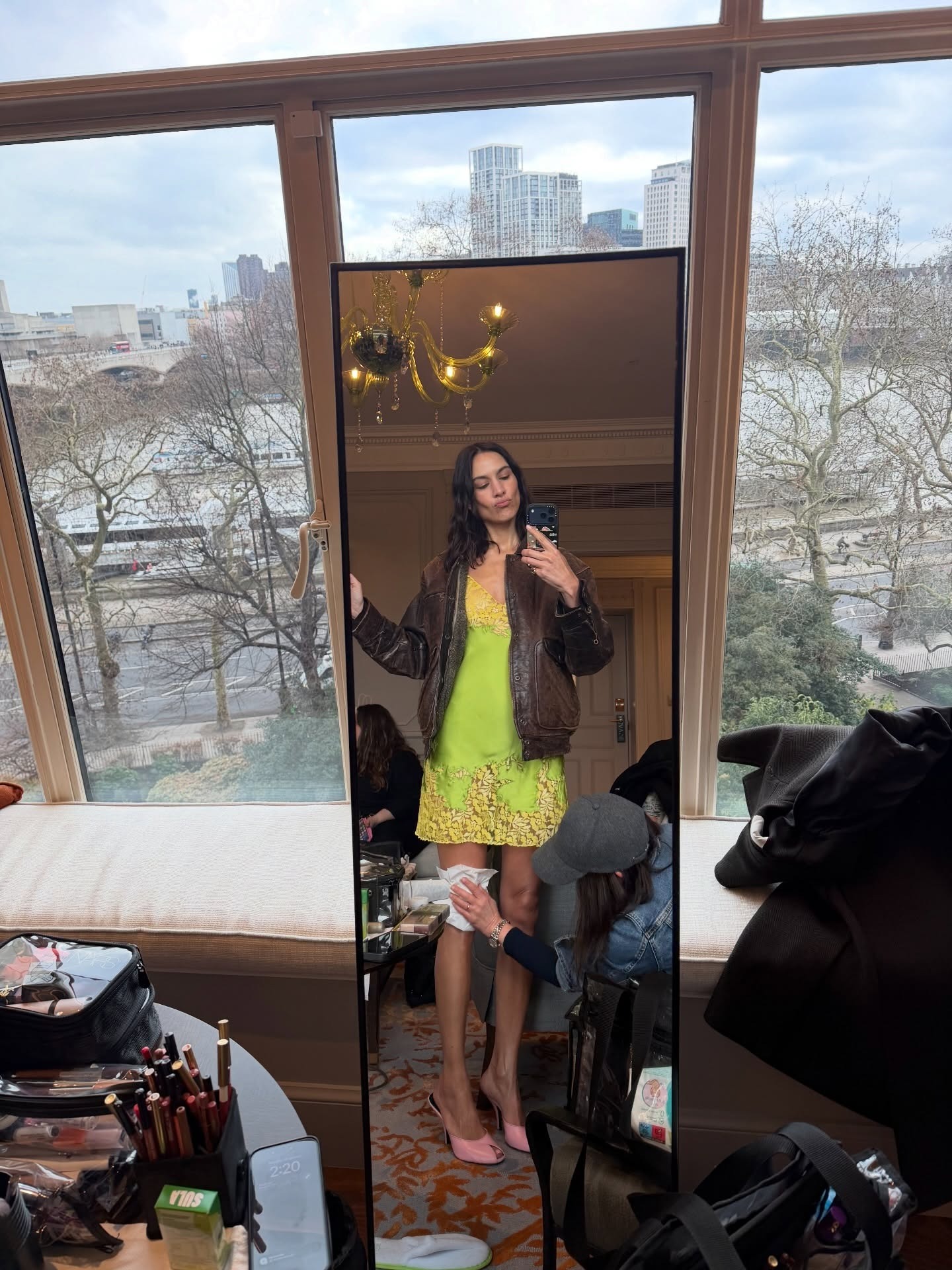 Alexa Chung in London wearing a lace slip dress with high heels.