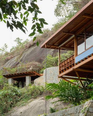 casa quinta by arquipelago, a wooden house on stilts above the rainforest canopy engulfed in greenery and open to nature