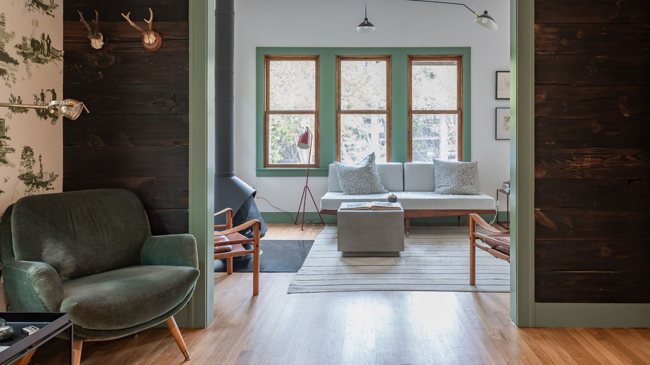 A living room area rug with an accent chair and sofa 