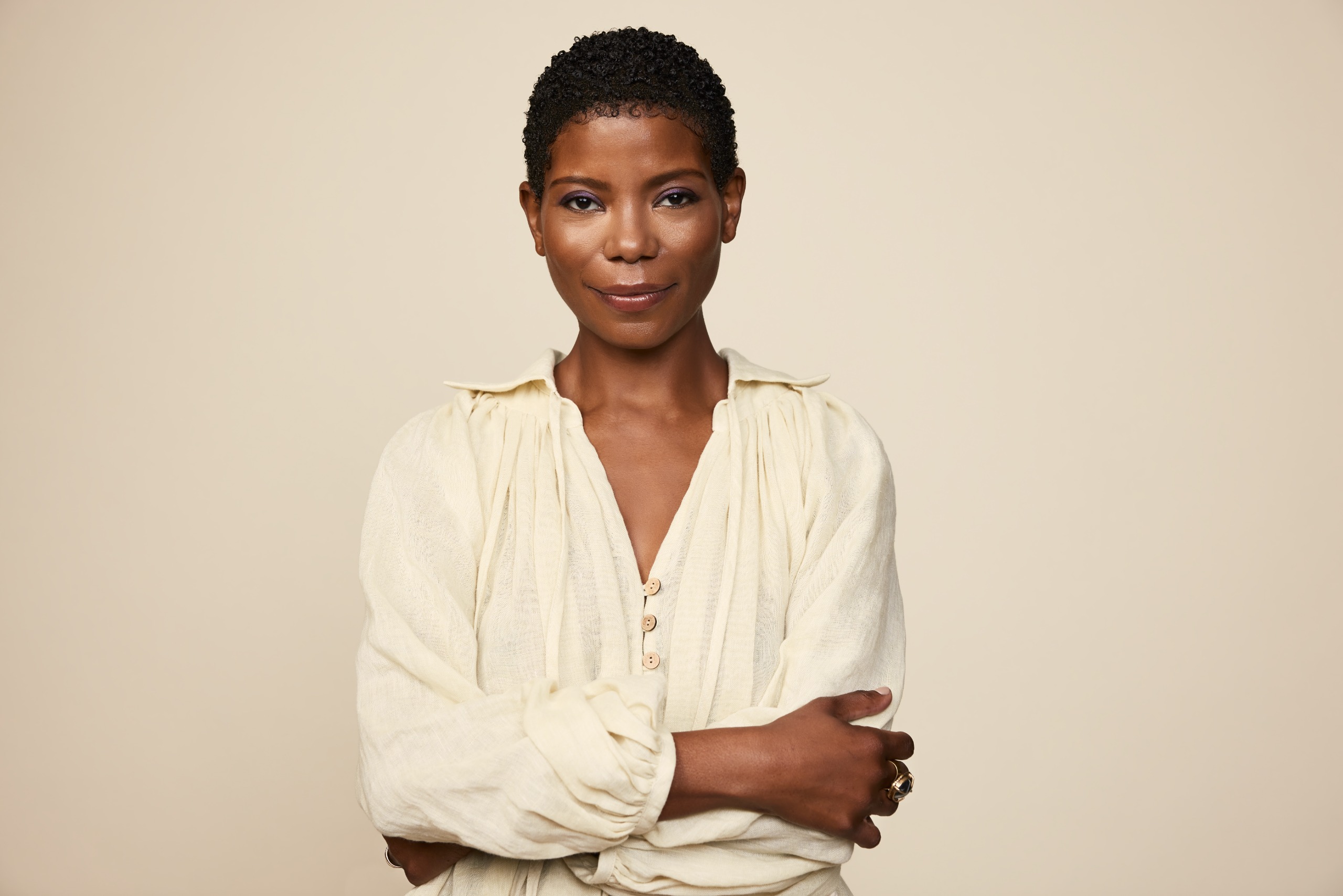 a black woman with short dark hair in a white shirt