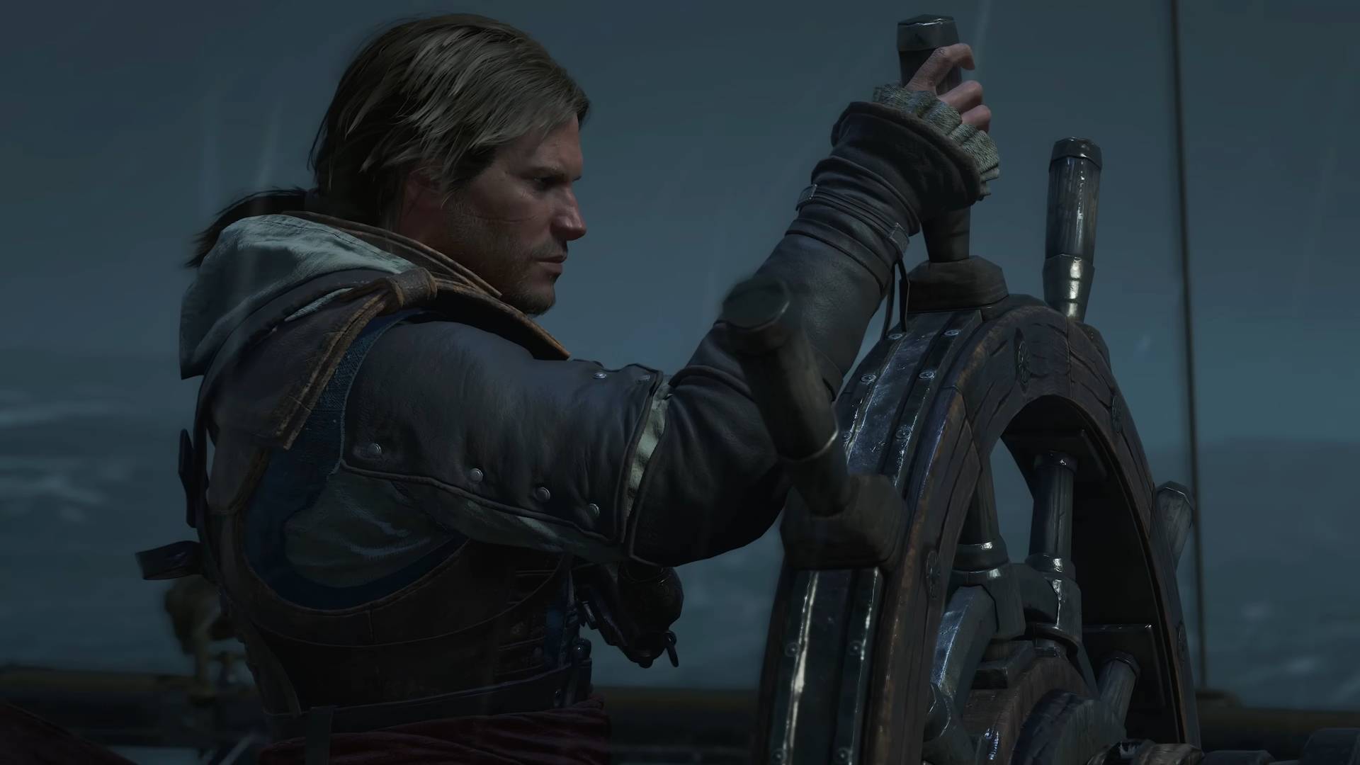 Assassin's Creed Black Flag Resynced screenshot from trailer showing edward kenway standing at the helm of a ship, holding the wheel in the rain