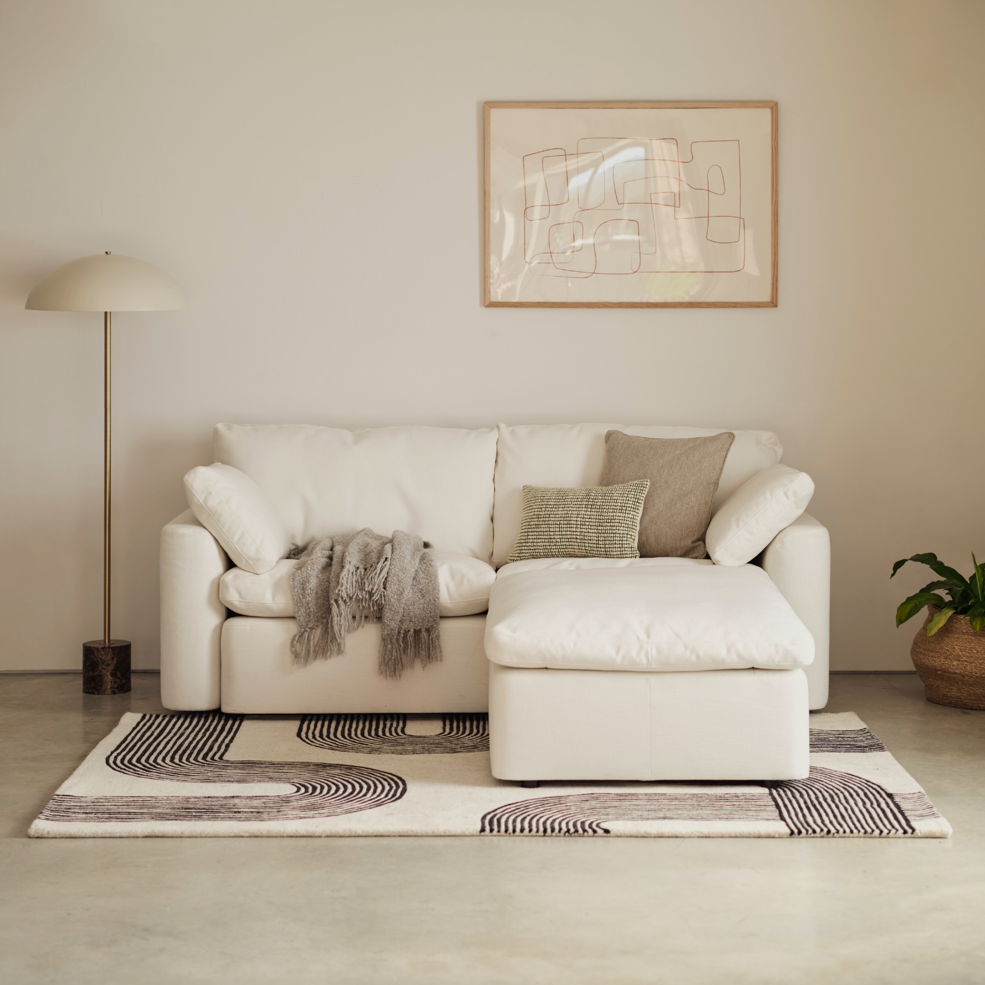 Swyft&#039;s Model 13 2-seater sofa in white with a matching ottoman
