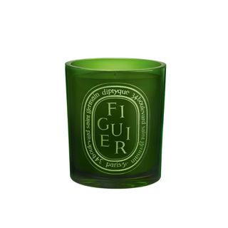 A large Diptyque Figuier scented candle in a dark green glass vessel.