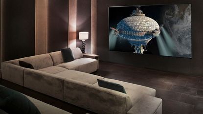 LG C1 85-inch TV mounted to wall opposite cream sofa in home cinema room
