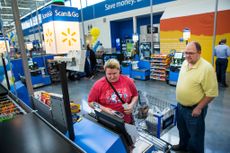 Walmart customers using Scan and Go checkout.