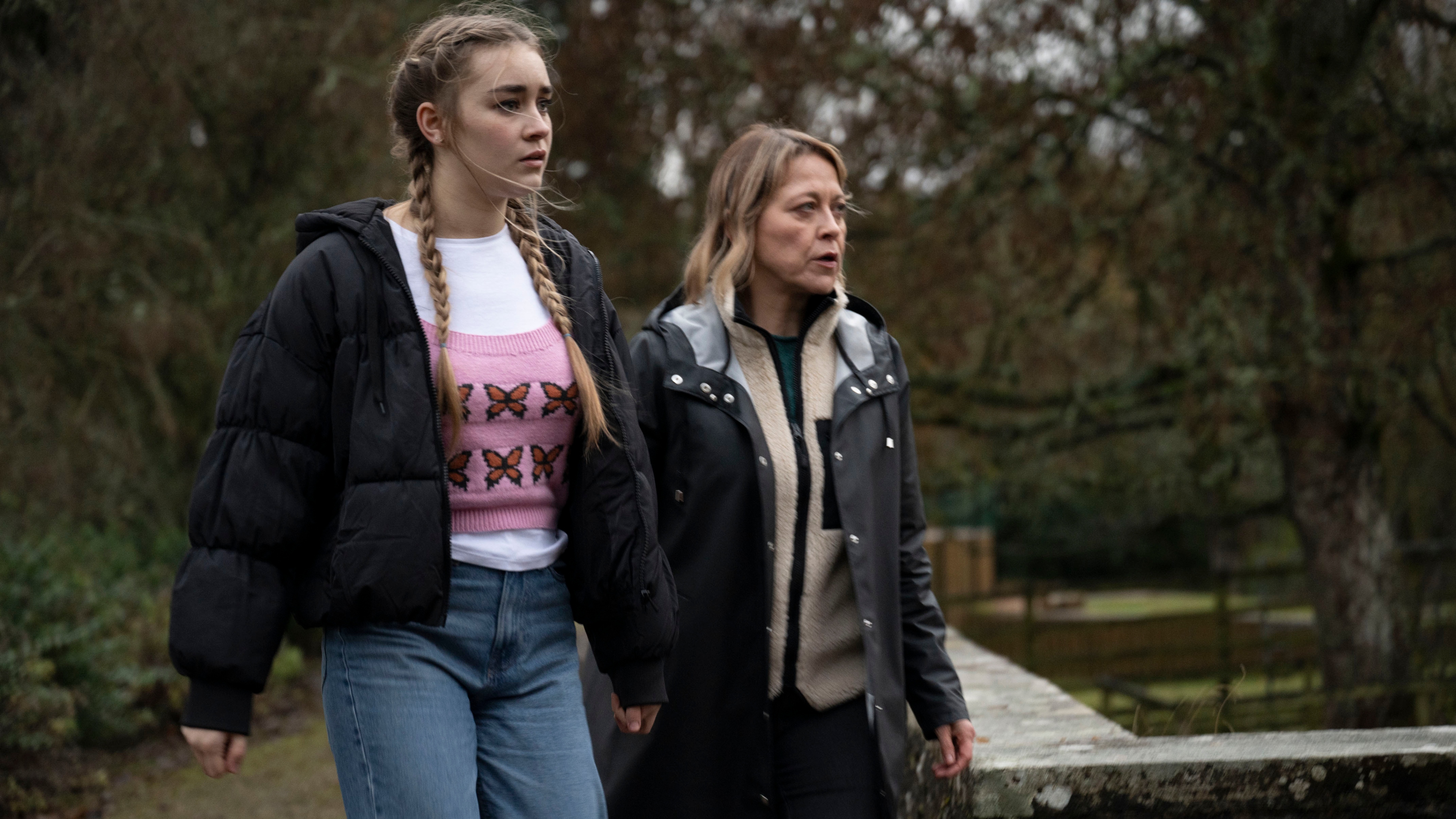 Morgan Strandhed (SILVIE FURNEAUX), DI Annika Strandhed (NICOLA WALKER) looking worried by a river