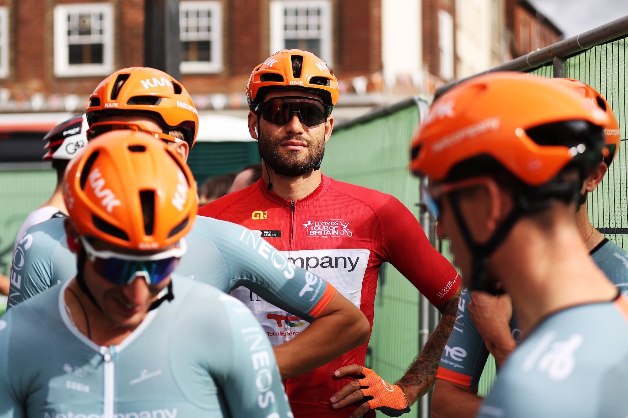 Filippo Ganna in the red jersey behind his teammates before the stage