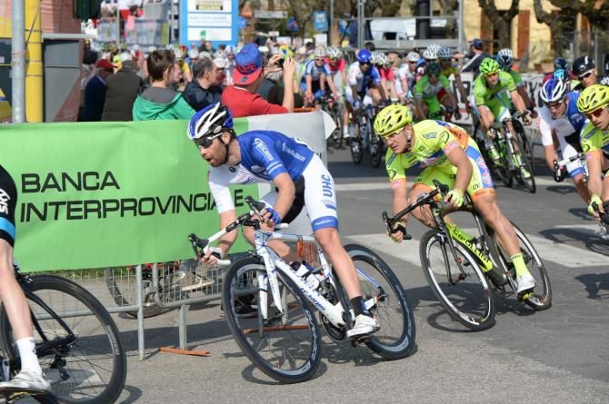 The riders take a late corner at speed