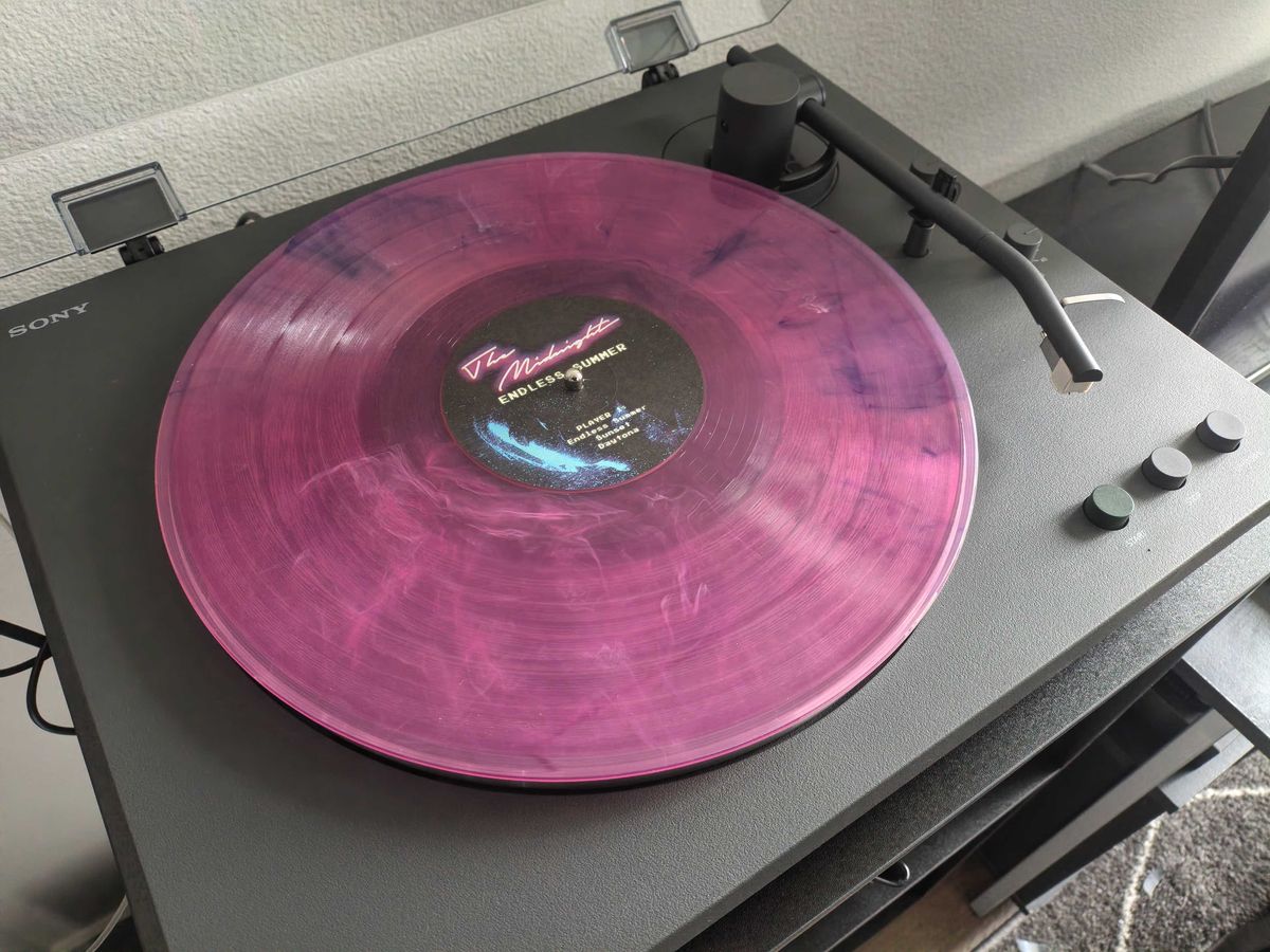 A pink vinyl on a record player