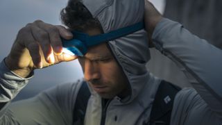 Hiker adjusting Black Diamond Storm 500R headlamp