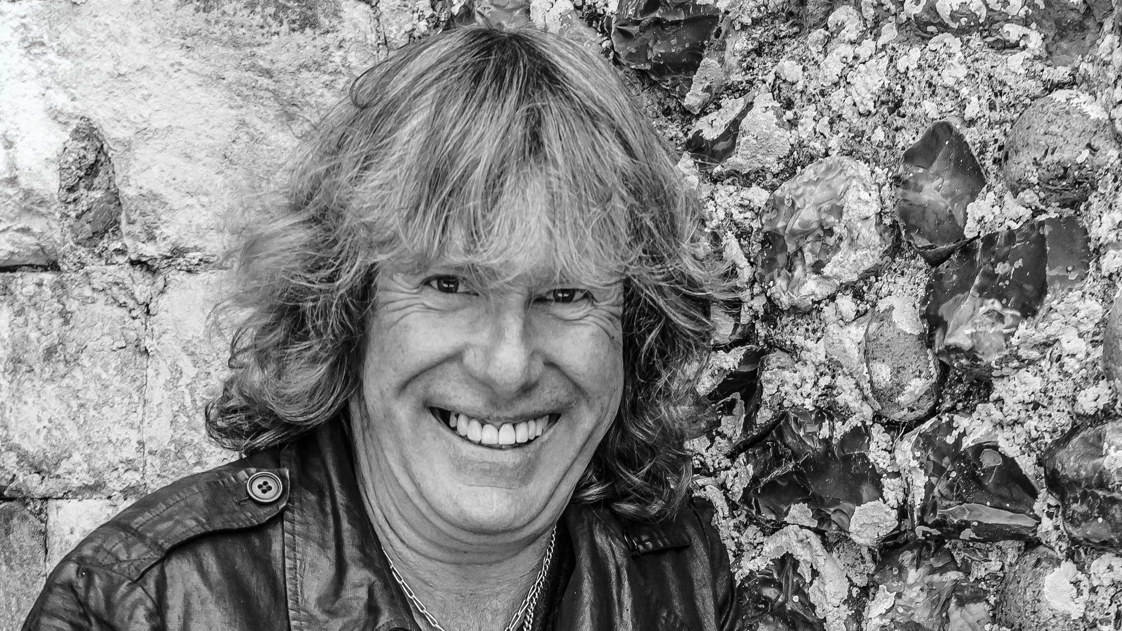 Black and white portrait of Keith Emerson smiling