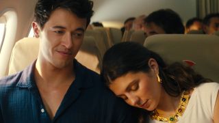 Alex smiling while Poppy leans against his shoulder. 