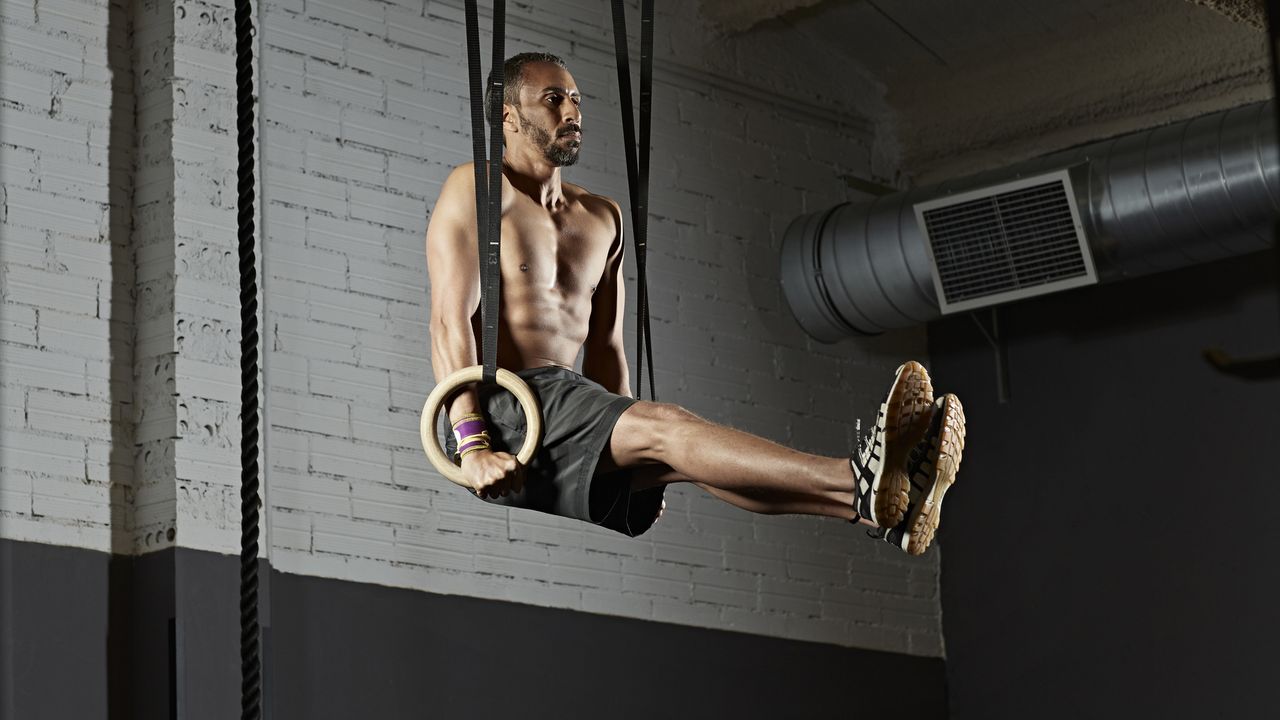 Gym training with gymnastics rings in gym