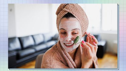 A woman with a face mask on using a facial roller 