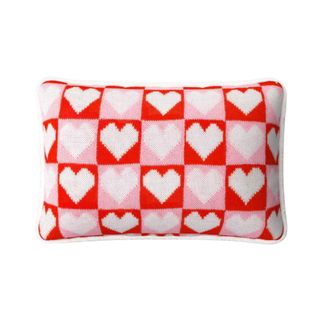 A checkered red, white, and pink heart throw pillow
