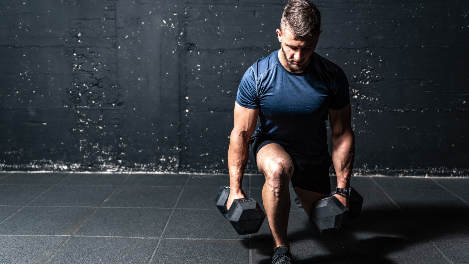 A man doing dumbbell lunges