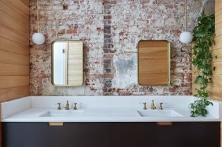 washroom with washbasin and brick wall