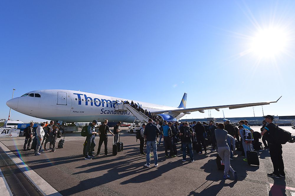 Teams line up to get on the charter plane that will take them to Italy.