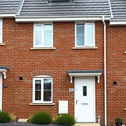exterior of house with brick wall and white door