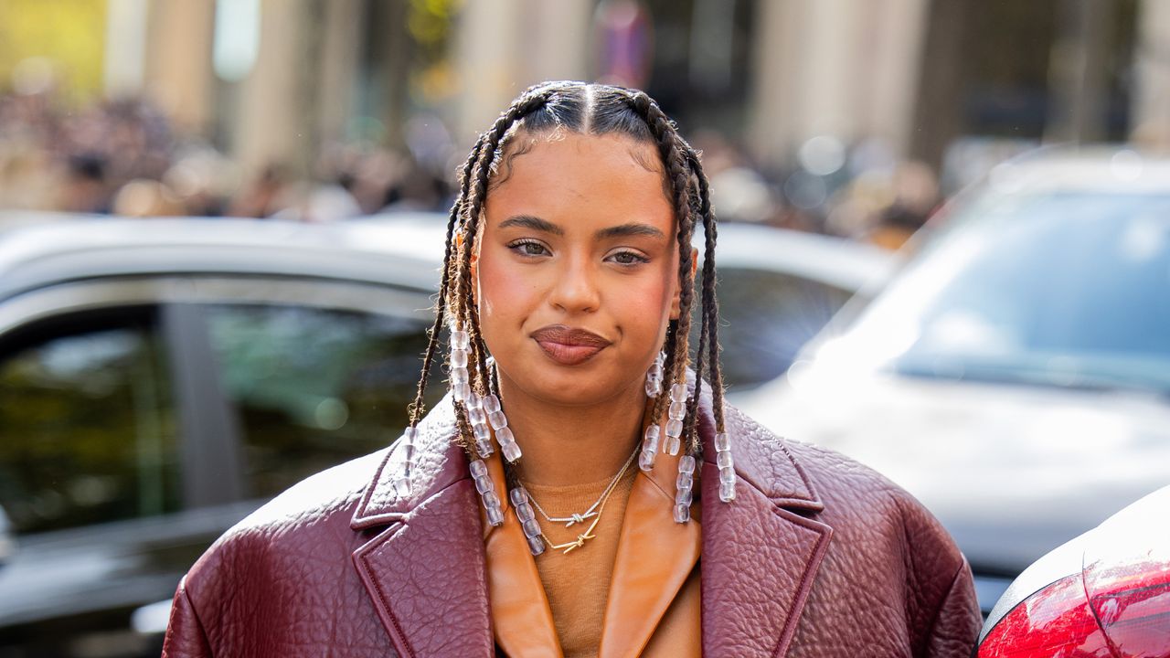 Paola Lacatelli wears burgundy jacket, brown bag, skirt, jacket outside Miu Miu during the Womenswear Spring/Summer 2024 as part of Paris Fashion Week on October 03, 2023 in Paris, France