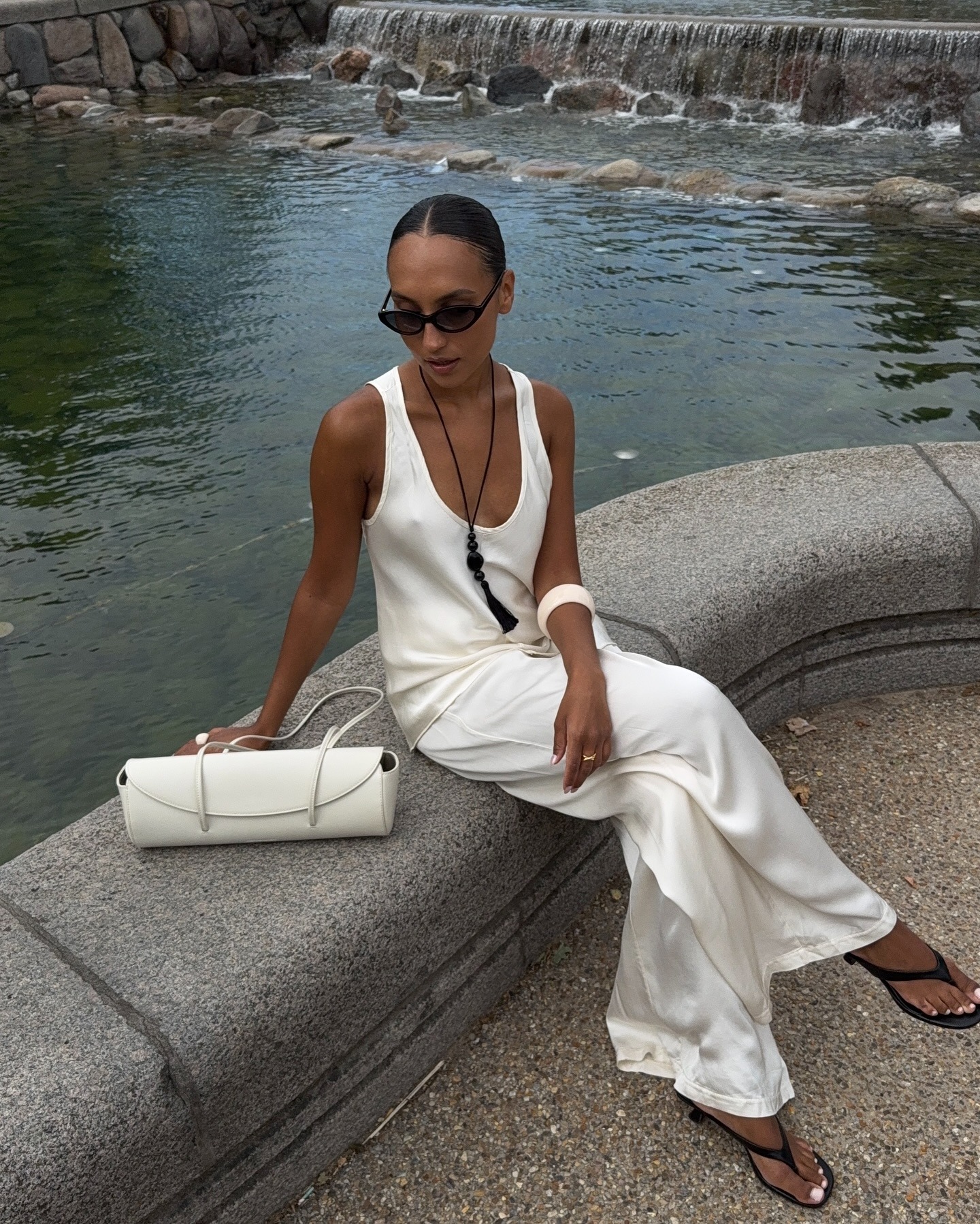 Woman in white silk top and pants