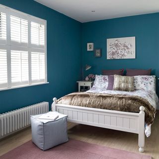 blue bedroom with laminated flooring