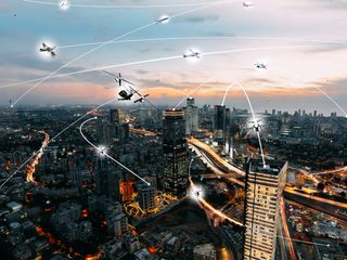 An artist's concept of an Urban Air Mobility environment, where air vehicles with a variety of missions can interact safely and efficiently.