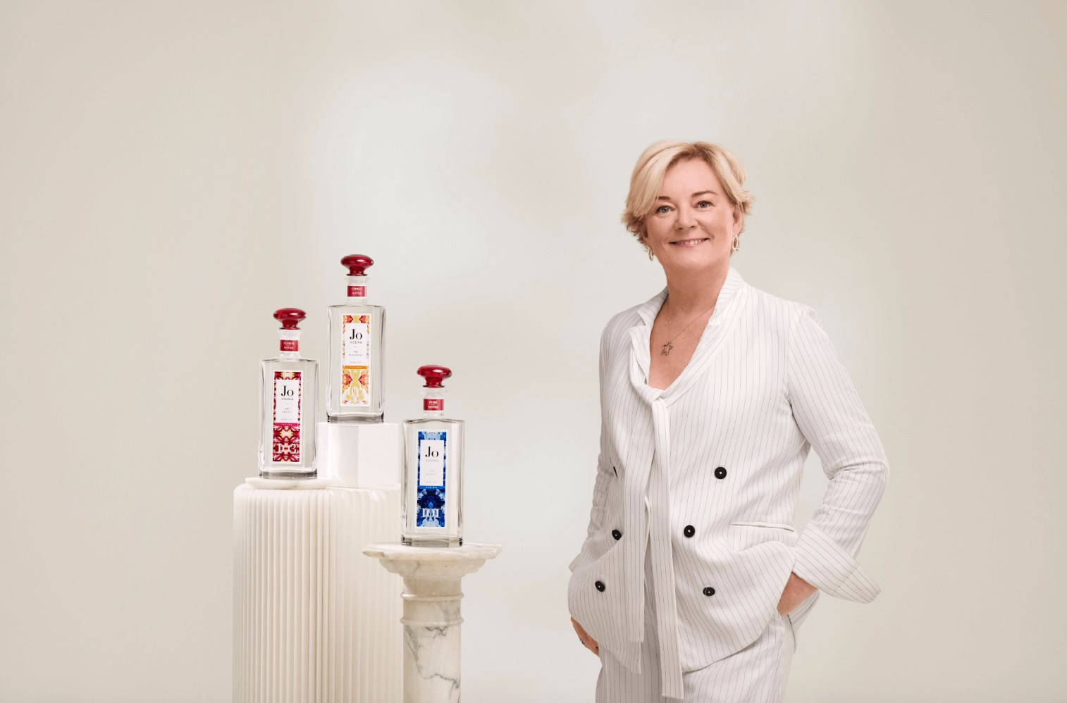 Jo Malone CBE, standing next to the three new vodka's