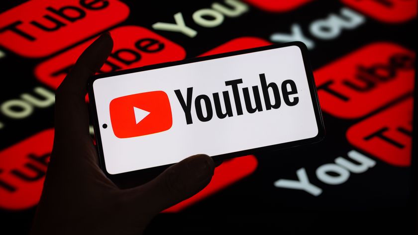 the YouTube logo on a screen in front of other YouTube logos covering a black background