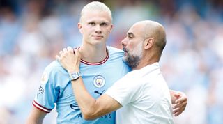 Erling Haaland of Manchester City interacts with Manchester City manager Pep Guardiola during the Premier League match between Manchester City and AFC Bournemouth at Etihad Stadium on August 13, 2022 in Manchester, England.