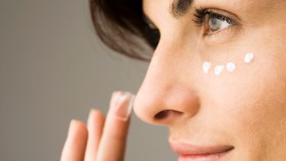 Woman applying eye cream