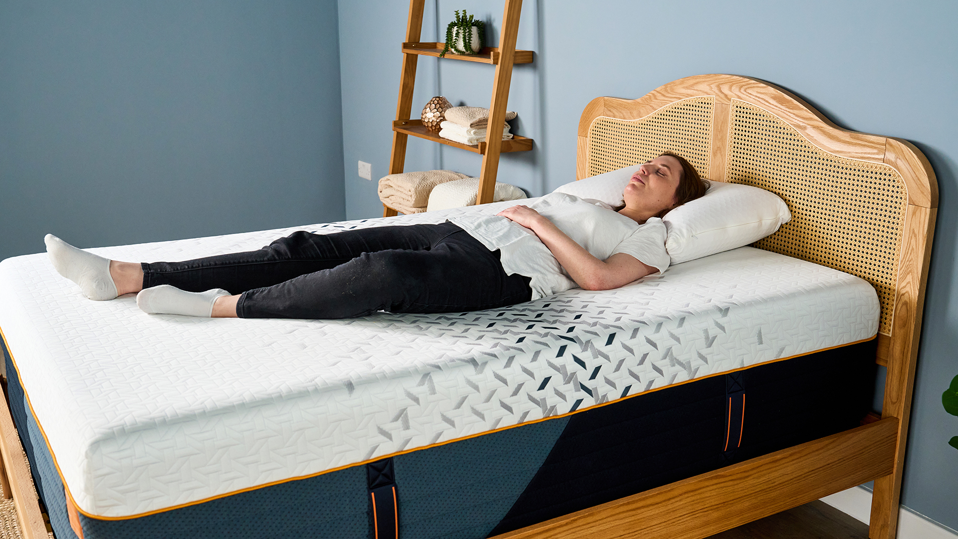 A female Tom's Guide mattress tester lying on her back sleeping on the Nectar Ultra Hybrid mattress