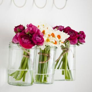 glass jar with roses and white flowers