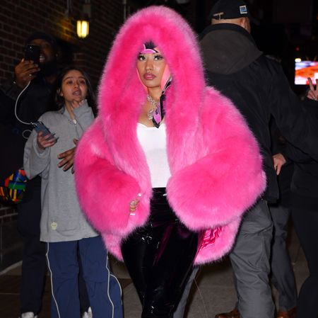 Nicki Minaj in a pink fur coat and yellow fur coat.