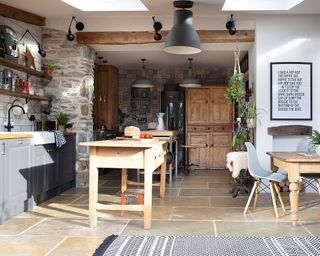 stone flooring in country style kitchen with open plan living and grey kitchen - CREDIT Katie Lee