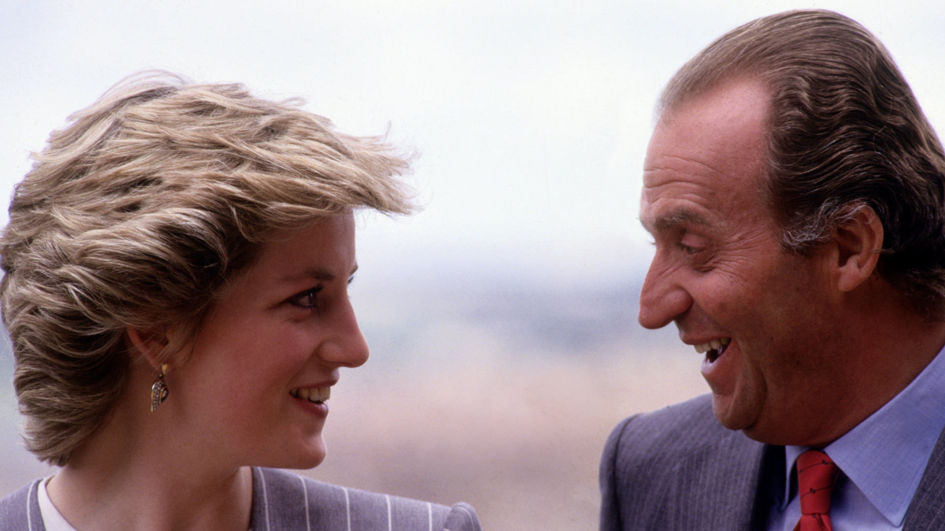 Princess Diana and King Juan Carlos facing each other smiling