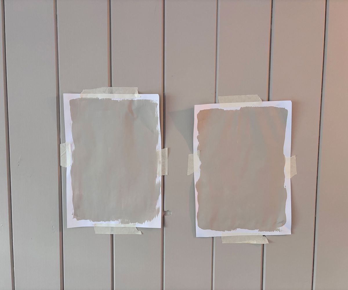 two paint samples on wooden wall panelling