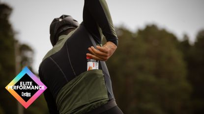 Male cyclist grabbing an energy bar from his jersey pocket