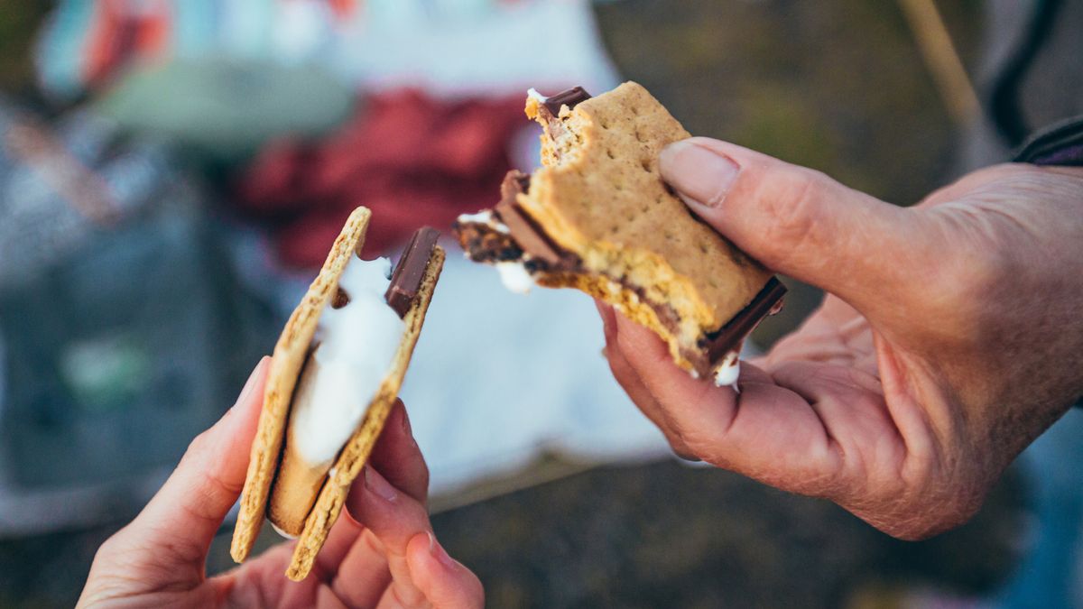 Two people holding their s&#039;mores together