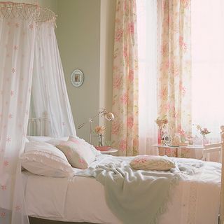 bedroom with coronet with drapes above bed and curtain