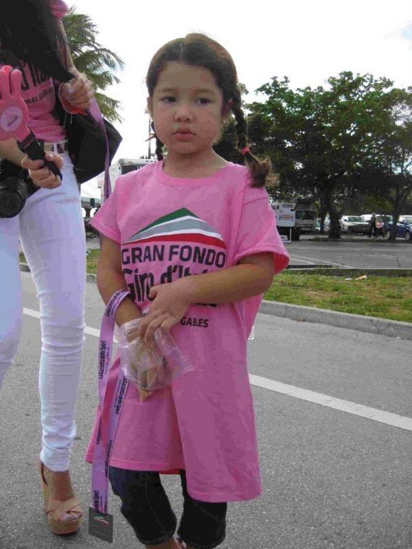 A young fan helping to hand out the finishing medals