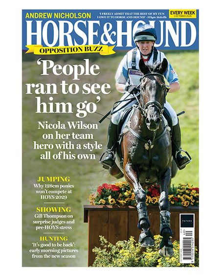 Nicola Wilson and Opposition Buzz jump a cross-country fence topped with red and yellow flowers towards the camera on the cover of Horse & Hound magazine, 1 October 2026 issue