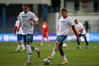 Erling Haaland and Martin Odegaard warm up for Norway in shirts reading: 'Human rights on and off the pitch'