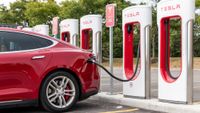 A Tesla Model 3 charging at a supercharger