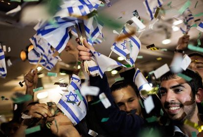 Supporters of the Israeli hard-line national religious party, Jewish Home, celebrate after general election exit polls were a