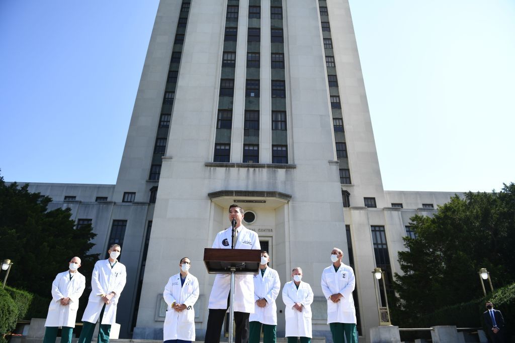 White House physician Sean Conley(C) answers questions surrounded by other doctors, during an update on the condition of US President Donald Trump, on October 4, 2020, at Walter Reed Medical 