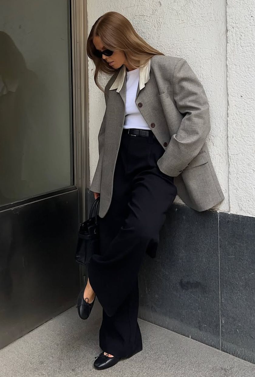 @haaannajohansson wears a grey blazer, white t-shirt, black wide-leg trousers, ballet flats and sunglasses